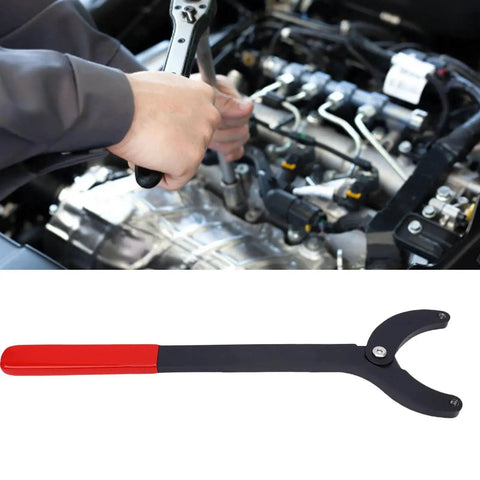 Camshaft pulley holder tool with adjustable jaws, steel construction, red and black handle, shown during engine repair.
