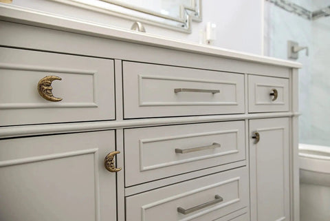 Bathroom cabinet with Set Of Six Gold Finish Cast Iron Crescent Moon Face Drawer Pulls For Celestial Decor installed.
