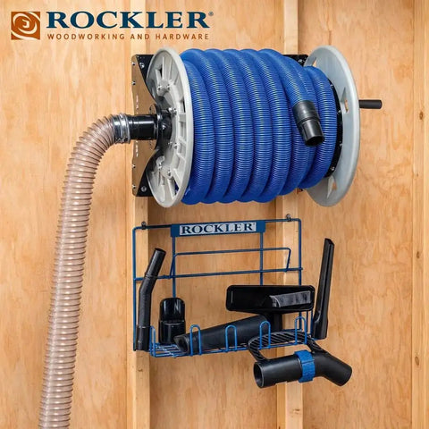 Shop Vacuum Hose Reel With 40 Ft Of 1.5 In Hose Wall Mount Steel Frame Adjustable Tension Knob Easy Install Dust Collector Accessory For Mess Free Cleanup In The Workshop mounted on wood wall with tools.