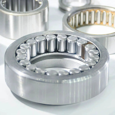 Close-up of cylindrical bearing with rollers in metallic silver tone, showcasing industrial bearing component design.