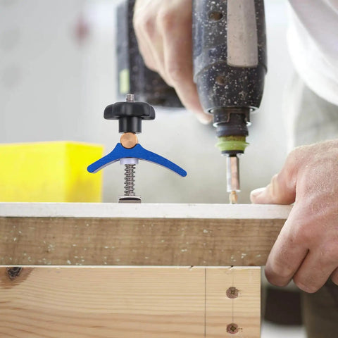 Pro Grade Woodworking T Slot Clamp With Hold Down Function Blue T Track Clip securing wood during drilling in workshop