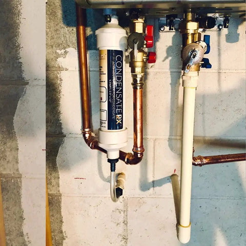 Condensate Neutralizer Kit for High Efficiency Boilers showing installed view with 1/2 FNPT, hose barb, 3/4 PVC adapters, white by American Valve.