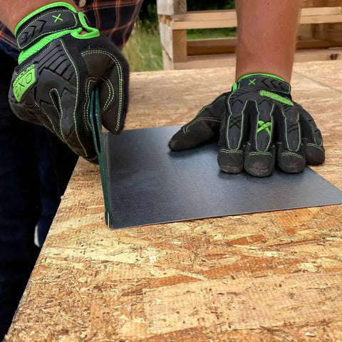 Person using 12 Inch Sheet Metal Folding Tool For DIY Pros Heavy Duty 24 Gauge Capacity, creating a precise bend on metal sheet.