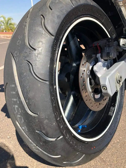 Forged Alloy Angled Valve Stem With Pre Applied Threadlocker Nut 0.357in Size Red 2 Pack visible on installed motorcycle wheel