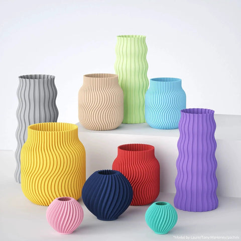 Assorted 3D printed vases in various colors showcasing designs made with Matte PLA Filament Teal Green 1kg 1.75mm For FDM 3D Printers