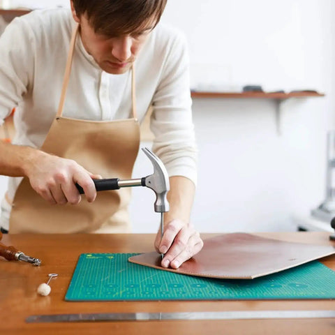 Person using Leather Hole Punch Set 1.5mm-5mm For Belts And Leather Crafting, Round Hollow Punches on leather sheet with hammer