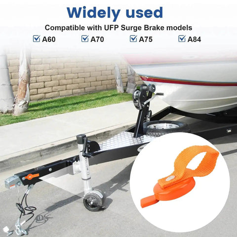 Orange QCG surge brake lockout key with strap, 2 pcs, shown on boat trailer hitch (front view).