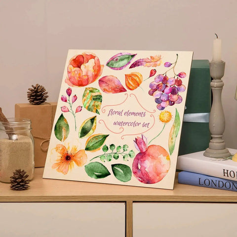 Canvas painting displaying a floral elements watercolor set, with vibrant flowers and leaves, placed on a wooden shelf.