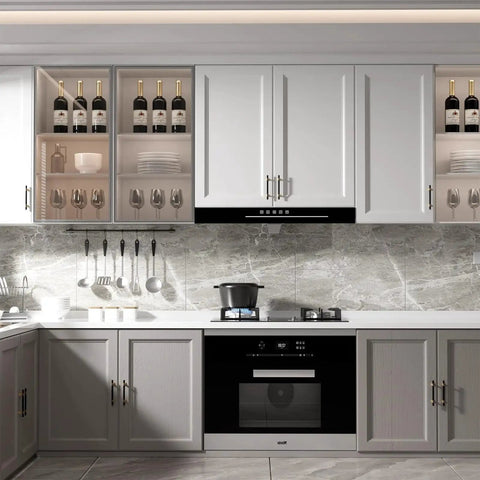 Modern kitchen with 10 Pack 3 Inch Hole Center Cabinet Handles In Black And Gold Matte Finish installed on white and gray cabinets.