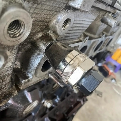 Broken Stud Remover Tool Three Eighths Inch Bolt And Stud Extractor installed on engine manifold for damaged studs removal
