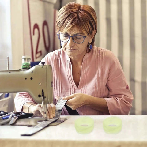 Woman sewing with machine and 20 pack rubber drive belts for sewing machine motors replacement parts visible on table