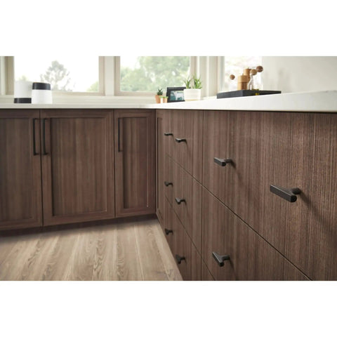 Riverside 6 5/16 Inch Center To Center Honey Bronze Cabinet Pull in modern kitchen setting on wooden cabinets.