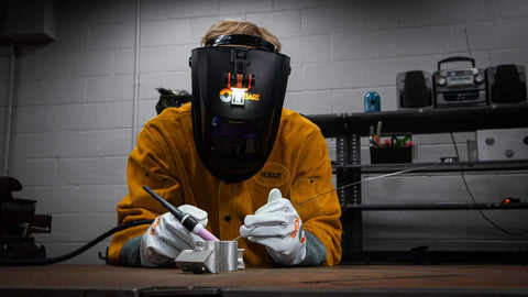 Welder using Hobart helmet with Helmet Mounted LED Welding Light Attachment for Inventor, Creator and Pillar Series Weld Helmets