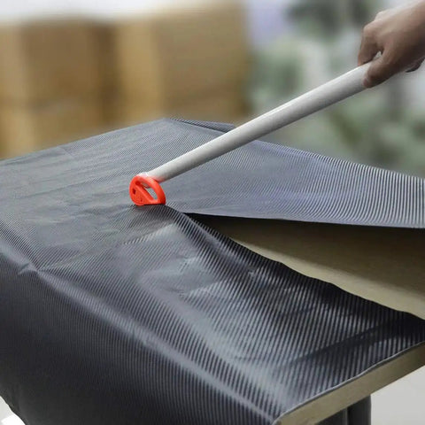 Vinyl Wrap Tool Kit For Car Wrapping And Window Tinting With 4 Inch Felt Squeegee being used on carbon fiber vinyl sheet