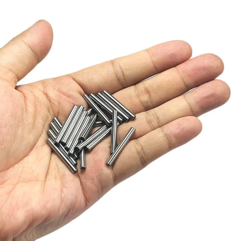 Hand holding 1/8 inch dowel pins, 20 pieces, one inch long metal shelf pins, alloy steel wood dowel pins for shelves and bunk beds.