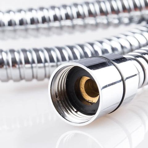 Close-up of a chrome-plated shower hose with a threaded connector against a white background.
