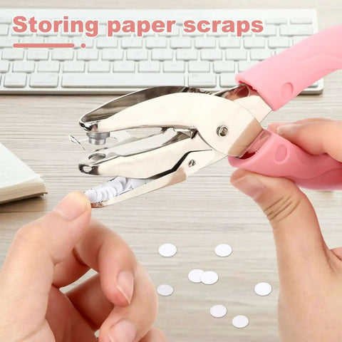 1/4 Inch Circle Hole Punch Handheld Paper Punch with pink grip for crafts and scrapbooking shown punching paper on a desk