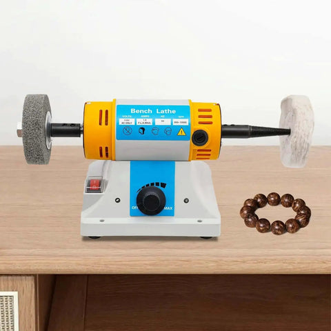 Pro Grade Bench Top Polisher And Grinder For Sanding Grinding And Polishing With 320W Motor And Variable Speed 800 To 10000 RPM 110V Yellow Industrial Tool Includes A Full Accessory Kit For Workshops Makers And DIYers on a wooden workbench.
