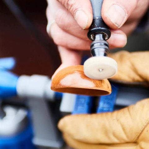 Person using Go To 160 Piece Rotary Tool Accessory Kit With EZ Lock Technology for carving and polishing wood with a polishing wheel.