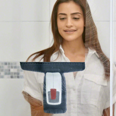 Bosch GlassVAC battery window vacuum cleaner held against glass; black squeegee head, white body.