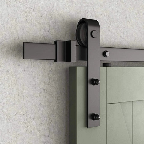 Close-up of installed J-shape sliding barn door hanger on track, black solid steel with POM wheels for smooth door movement.