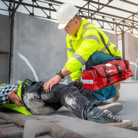 Construction worker using Complete 415 Piece Emergency Response First Aid Kit Trauma Bag For Disaster Preparedness Reflective Red MFASCO