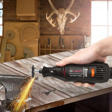 Versatile Rotary Tool Kit with Keyless Chuck and Flex Shaft in use, sparks flying from metal viced on a workbench in workshop