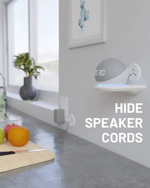 Modern kitchen counter with fruit, wall-mounted speaker, and text reading 'Hide Speaker Cords.'