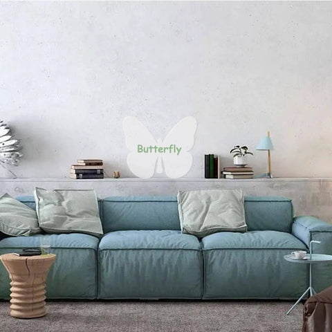 Wall-mounted butterfly decor behind a blue sofa in a modern living room