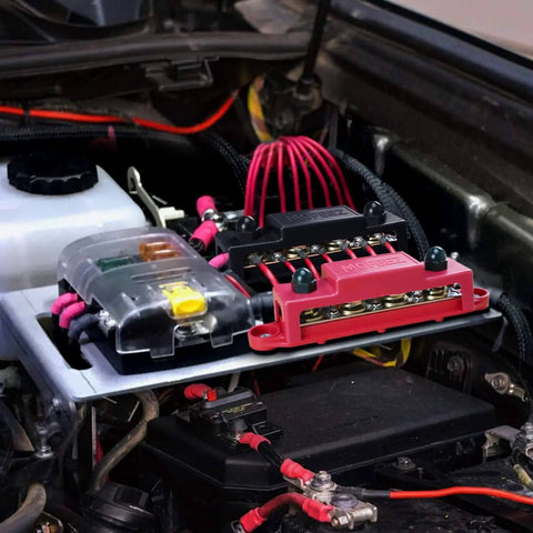 High Current Power Distribution Block Bus Bar For 48 Volt Systems, Four Five Sixteenths Inch Posts, Six Number Eight Screws, installed in engine