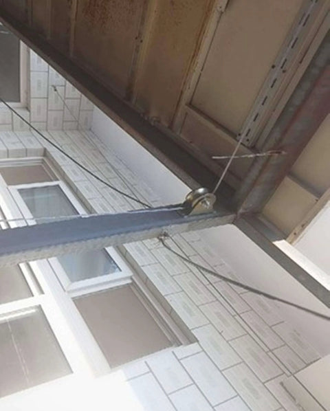 V Type Groove Sliding Gate Roller With Steel Track Wheel, Double Bearings, installed on wire rope rail for sliding door