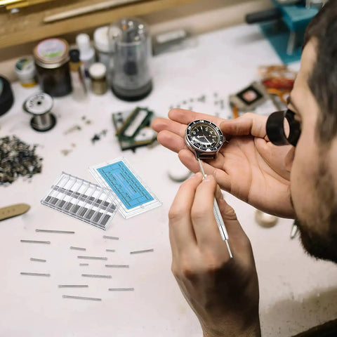 Watchmaker using 360 Piece Watch Band Pins Kit, Stainless Steel Cotter Pins, Replacement Link Pins For Watch Bands, 18 Sizes, 6 To 23mm, Assortment, Handy DIY Repair Kit For Watchmakers on a wristwatch.