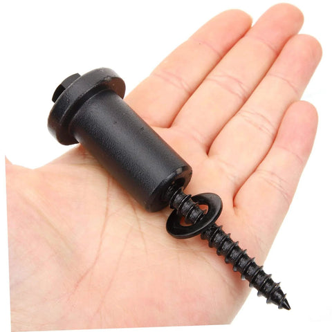 Hand holding a black spacer with screw from Sliding Barn Door Track Spacer Kit 4 Pack Connectors For Reliable Door Repair Easy To Install With Heavy Duty Carbon Steel Hardware And Adjustable Wall Clearance.