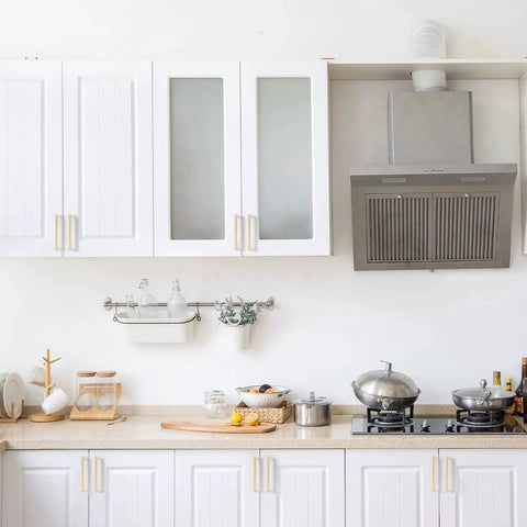10 Pack 5 Inch Brushed Gold Cabinet Pulls Zinc Alloy Handles installed on white kitchen cabinets with a modern stove and range hood.