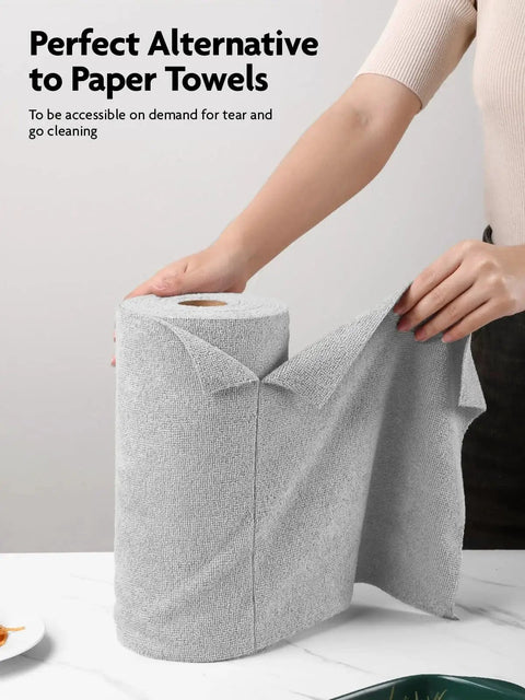 Person tearing a sheet from 12x12 Inch Tear Away Microfiber Cloth Roll 40 Pack Reusable Washable Towels in kitchen setting.