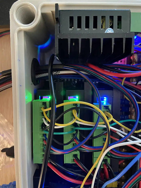 Close-up of 4 Pack Stepper Motor Driver Kit For Nema 17 23 34 CNC Controllers installed in a control box, showing wiring and connections.