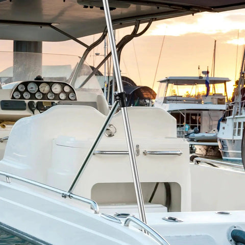 Installed adjustable marine-grade aluminum rear bimini top support pole on white boat; cockpit gauges visible.