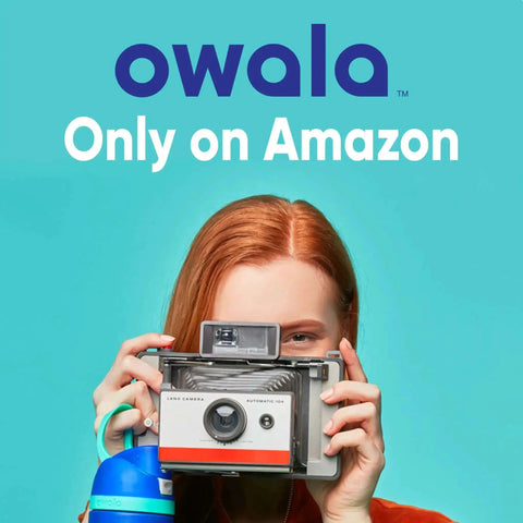 Person holding a vintage camera with a FreeSip Insulated Stainless Steel Water Bottle With Straw And Locking Push Button Lid in hand