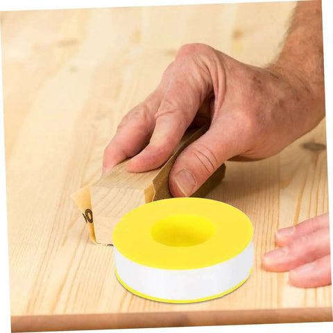 High Temp PTFE Sealing Tape Thread Sealant For Water Leaks on wooden surface with hand sanding background