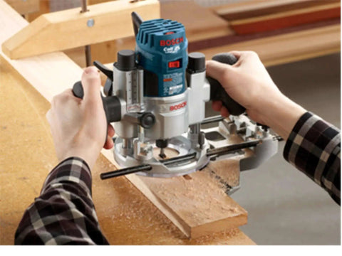 Person using 15 Piece Micrograin Carbide Tipped Wood Router Bit Set Universally Compatible For DIYers Finishing And Shaping Soft And Hard Woods And Wood Composites Bosch RBS015MBS on wood plank