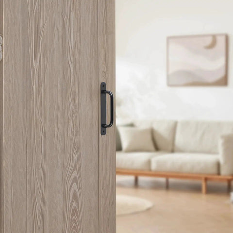 12 Pack 5.8 Inch Aluminum Alloy Black Cabinet Pulls With Screws installed on a light wood barn door in a modern living room setting.