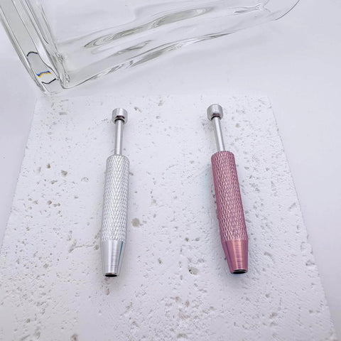 No Fuss Easy Change Piercing Taper Ball Grabber Tool Set in silver and pink, textured handles on a speckled surface.