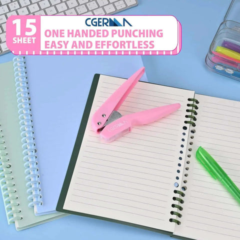 Lightweight Pink One Quarter Inch Hole Punch For Paper Cards And Cardboard With Fifteen Sheet Capacity placed on notebooks