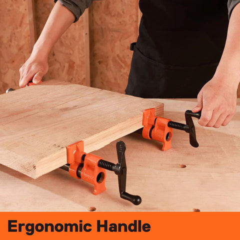 Two orange PONY pipe clamp fixtures with ergonomic black handles clamping a wooden board.