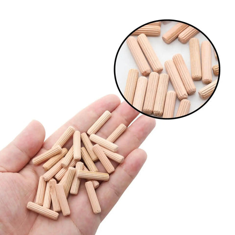 Wooden Dowel Pins 48 Pieces 6mm By 25mm And One Quarter Inch By One Inch Fluted Beveled Ends Hardwood Pegs in hand and close-up view