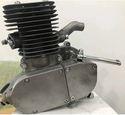 Gas engine cylinder for 2-stroke bicycle engine; aluminum-gray with cooling fins, side view showing exhaust bolts.