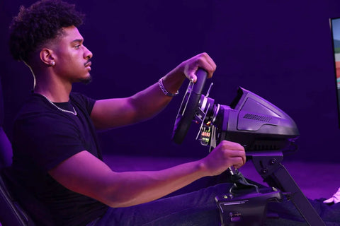 Front view of a person using a Turtle Beach VelocityOne sim racing shifter and handbrake on a black wheel setup