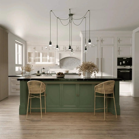 Modern kitchen with green island and pendant lighting, featuring wicker chairs and a backsplash, in a bright, open space.