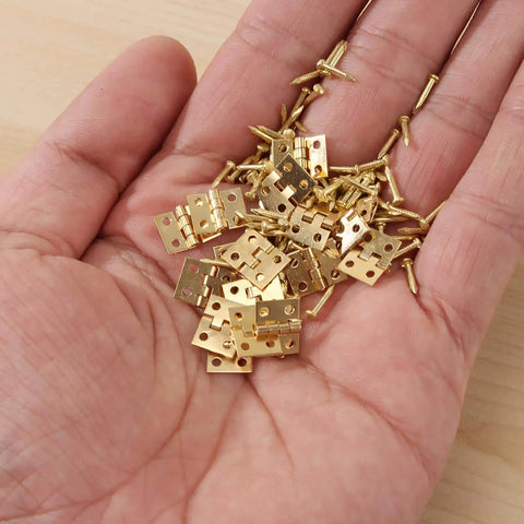 100 Pack Mini Hinges With 400 Replacement Screws In Gold Copper Finish Four Hole Butt Hinges 10x8mm in hand, for jewelry cases.