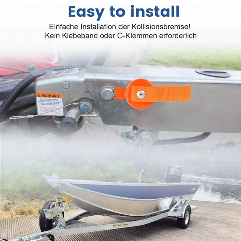 Orange surge brake lockout key with magnetic lockout mounted on a boat trailer hitch.